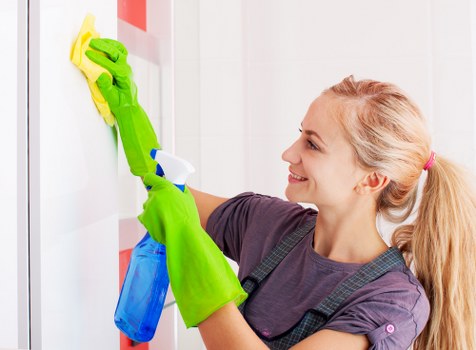 Cleaner treating a fabric sofa in a Bayswater living room